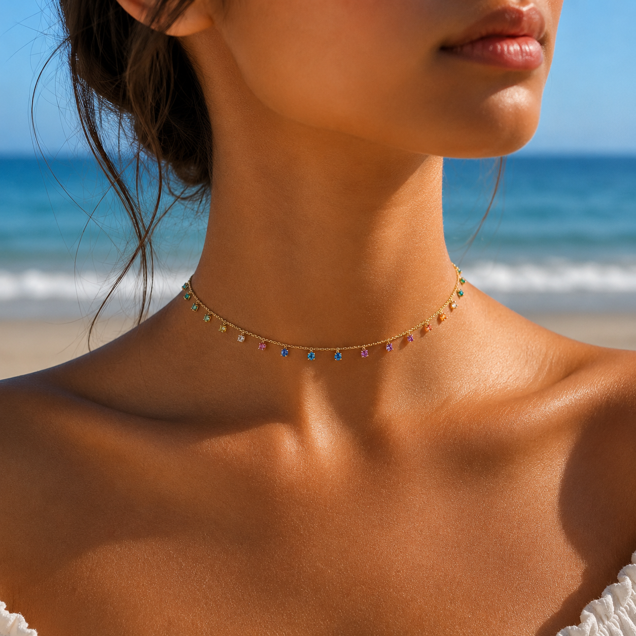 Close-up of a woman wearing a colorful necklace with a beach in the background in india