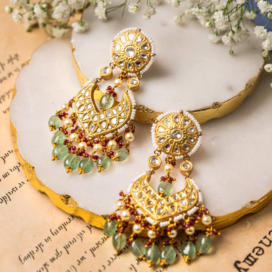 Traditional gold chandelier earrings with emerald and Polki diamond detailing