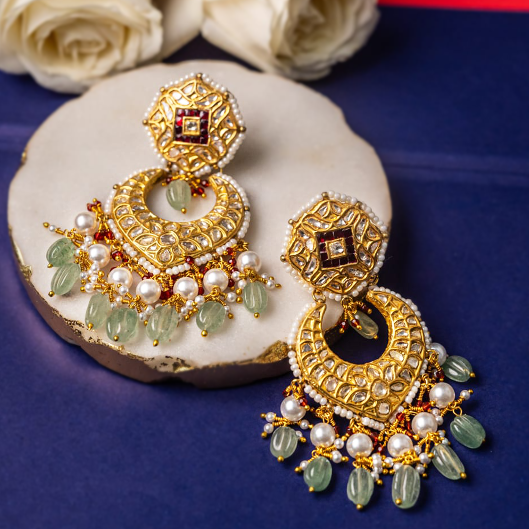 Polki diamond chandelier earrings with emerald accents, hand-finished gold detailing