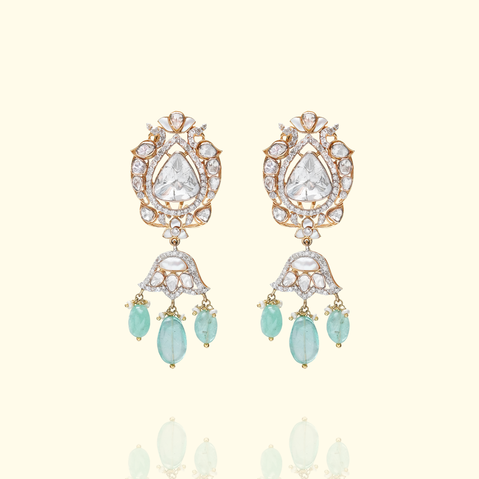 Pair of gold Polki drop earrings featuring bird-motif studs and bell, dome shaped, jhumka dangles with light green emerald gemstone droplets.