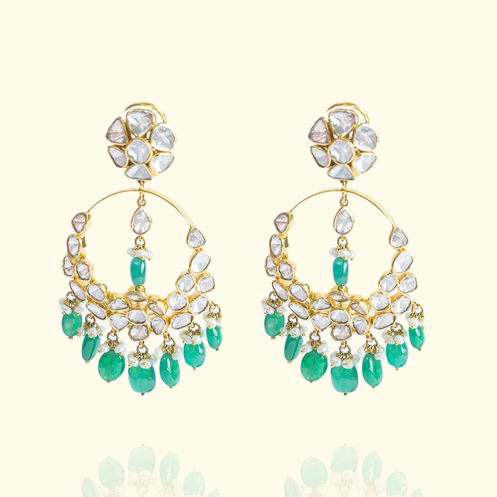 Gold chandelier earrings with emeralds and Polki diamonds, perfect for weddings and occasions