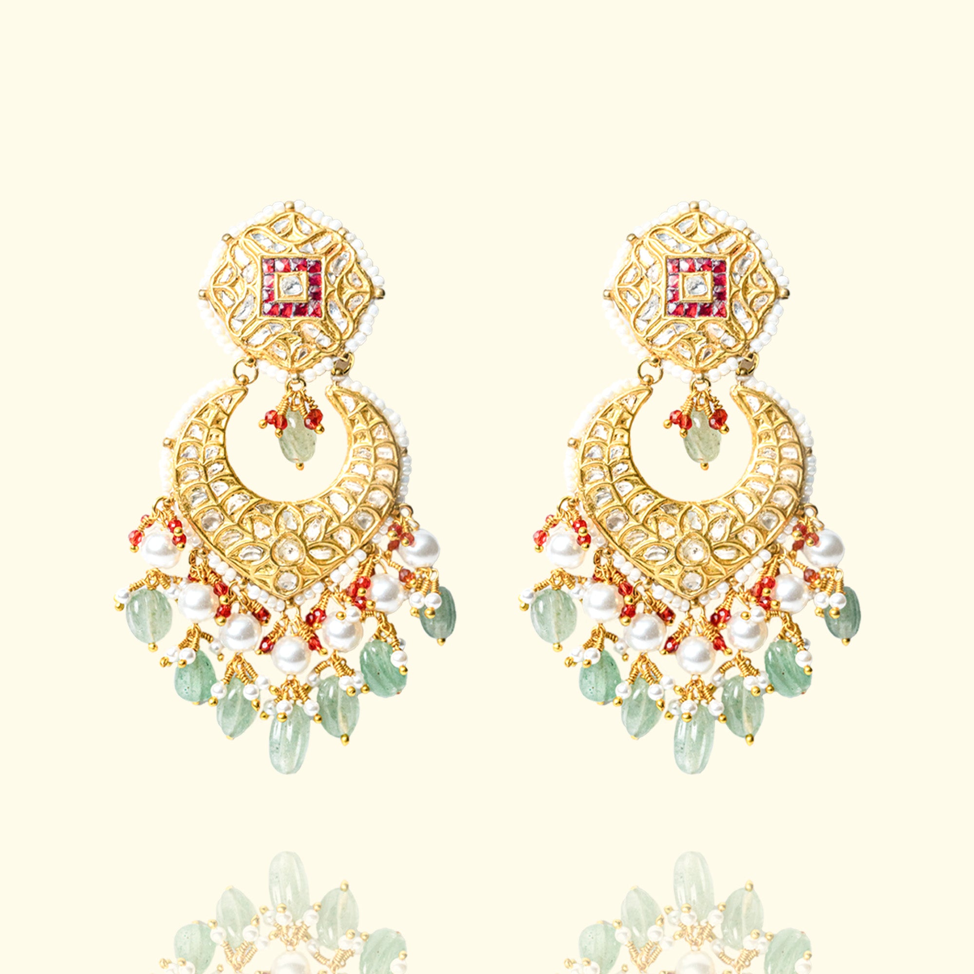 Polki diamond chandelier earrings with emerald accents, hand-finished gold detailing