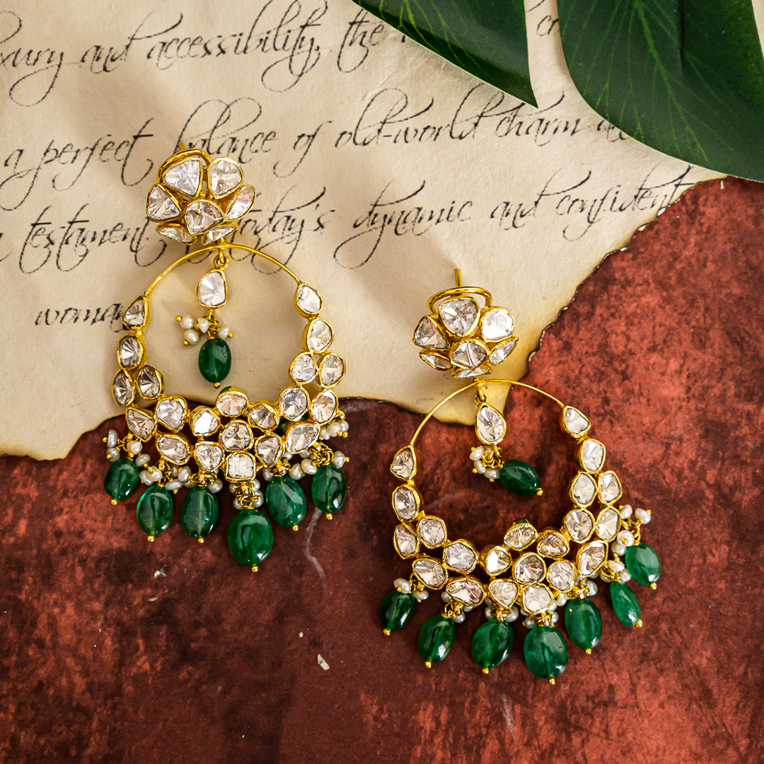 Gold chandelier earrings with emeralds and Polki diamonds, perfect for weddings and occasions