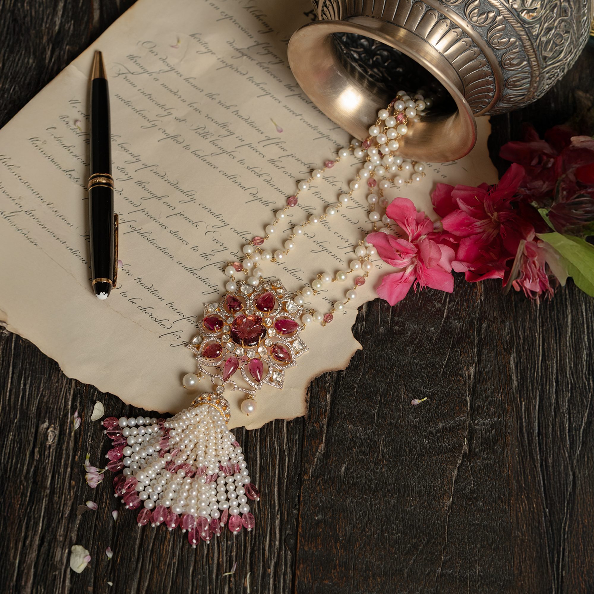 Ornate floral polki pendant necklace featuring pink tourmaline petals, uncut diamonds and a cascading white pearl tassel with pink gemstone droplets.