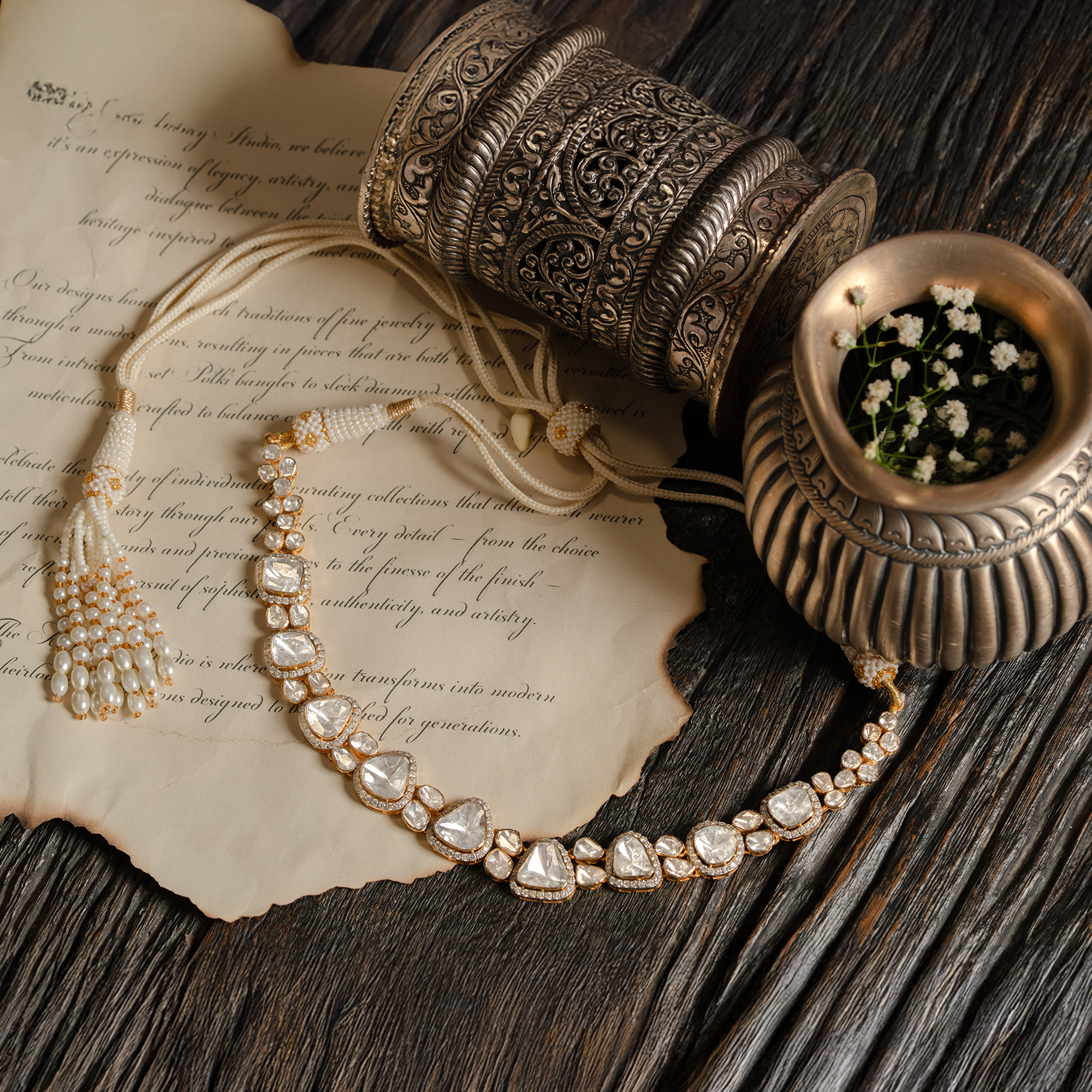 A model wearing a sophisticated gold choker necklace featuring a graduating sequence of triangle-cut polki diamonds in individual diamond-pavé frames.